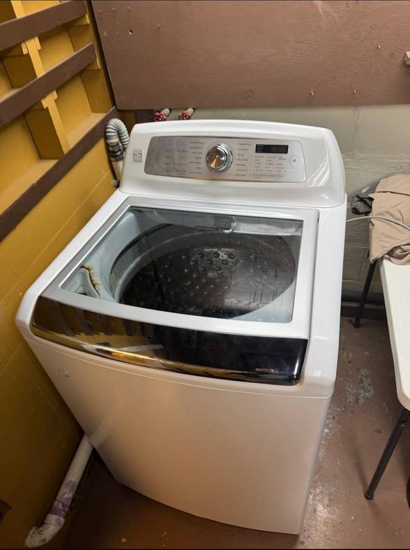 Top-load washing machine being serviced by NYC Sub-Zero & Viking Appliance Repair technician